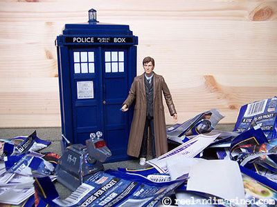 Toy TARDIS among empty Doctor Who sticker packets Toy TARDIS among empty Doctor Who sticker packets